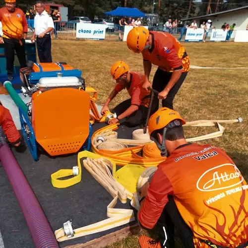 Firefighters competing with fire hoses