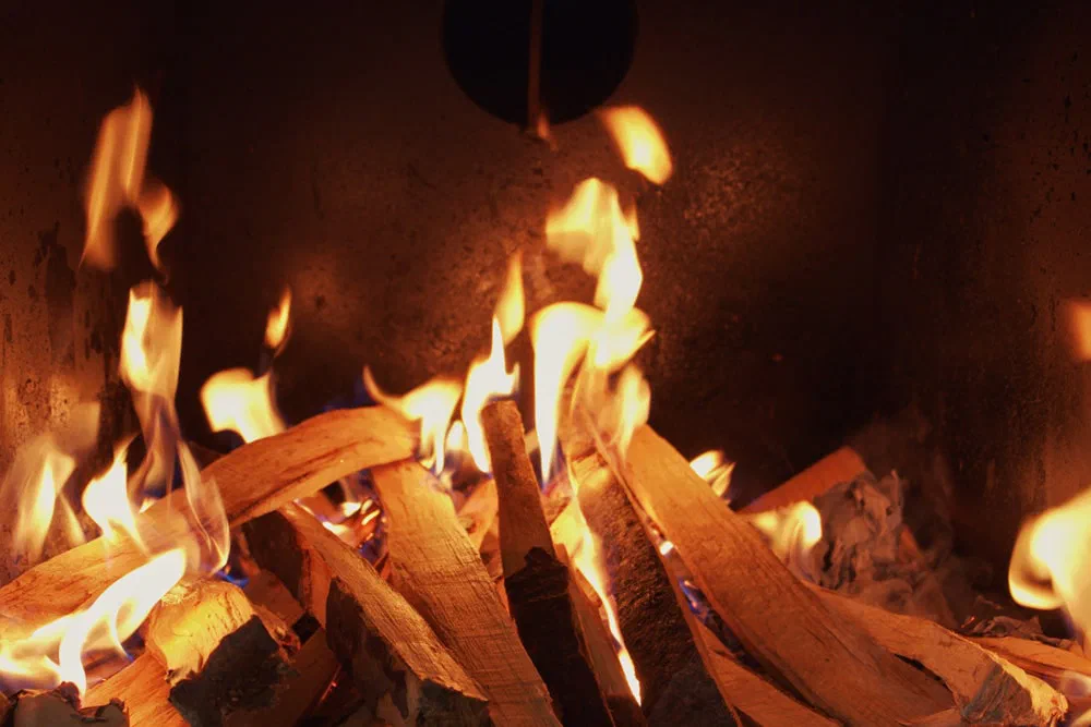 Flames and burning logs as an ATTACK DPX boiler is lit