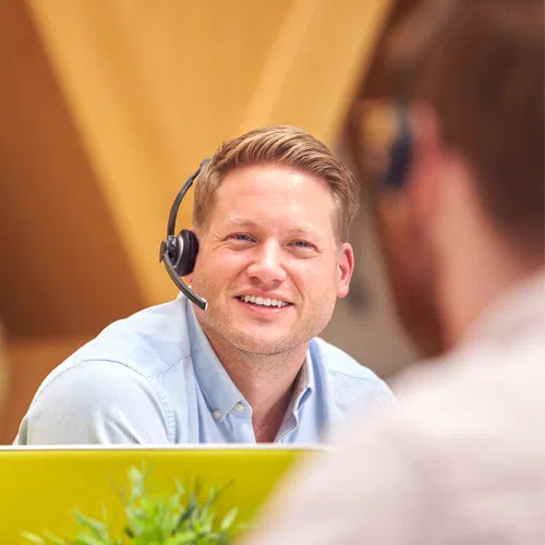 ATTACK customer support employee wearing a headset